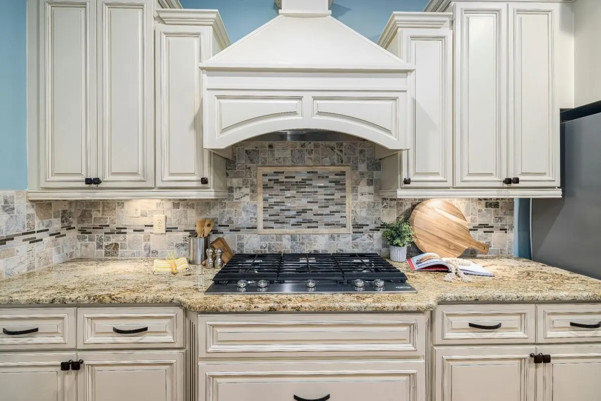 Open concept kitchen with quartz counters and custom cabinetry