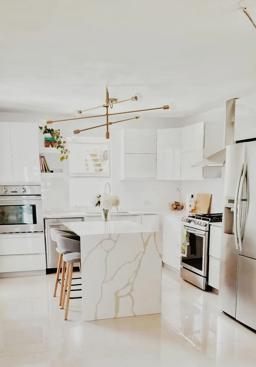 Open concept kitchen with quartz counters and custom cabinetry